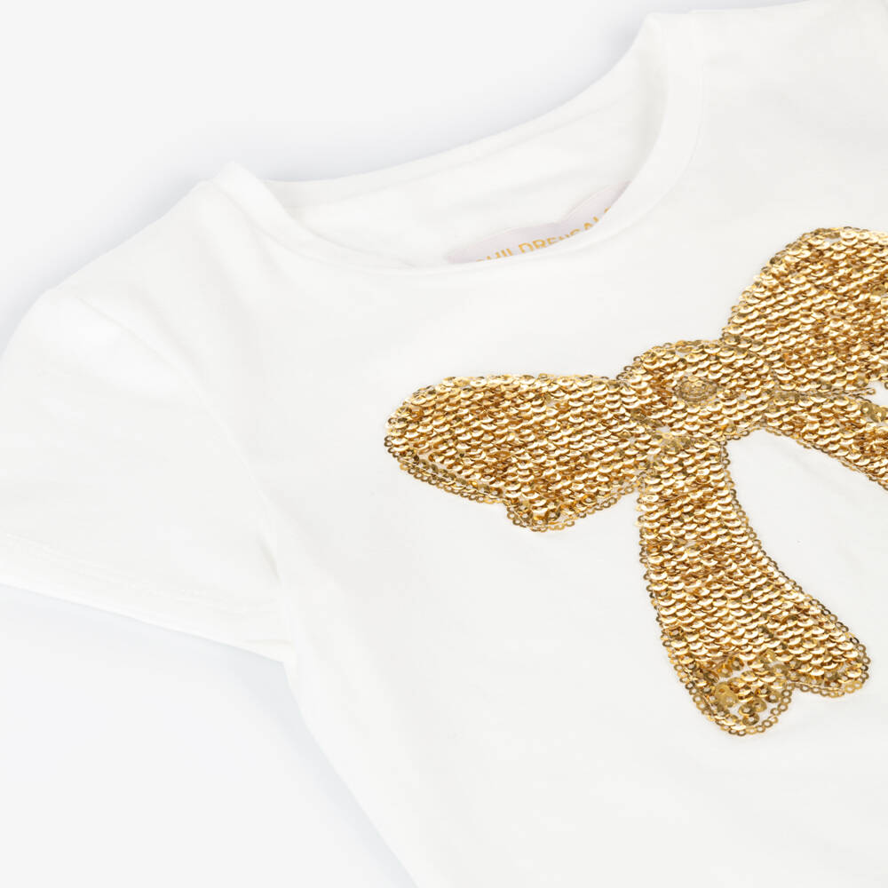 تشلدرن صالون-تيشيرت قطن جيرسي مزين بفيونكة ترتر لون عاجي وذهبي للبنات | Childrensalon Outlet