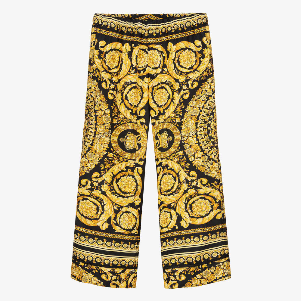 Versace - Черно-золотистые шелковые брюки с принтом Barocco  | Childrensalon